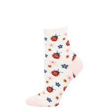 White sock with colorful ladybug and flower pattern on a white background